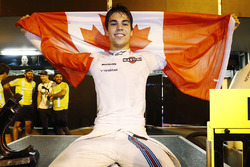 Lance Stroll, Williams FW40, celebrates third place by displaying a Canadian flag in the pit lane
