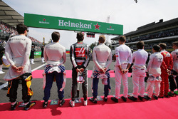 The drivers as the grid observes the national anthem