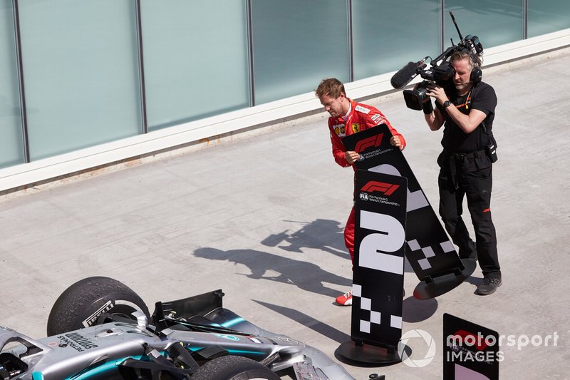 Sebastian Vettel, Ferrari, 2nd position, switches the position boards in protest of a penalty that cost him victory