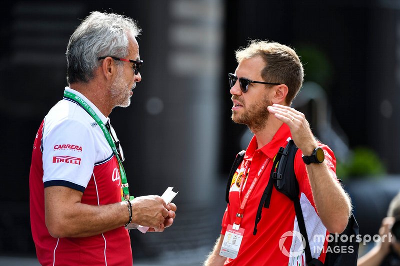 Beat Zehnder, Team Manager, Alfa Romeo Racing and Sebastian Vettel, Ferrari in the paddock
