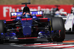Daniil Kvyat, Scuderia Toro Rosso STR12, lifts a wheel over a kerb