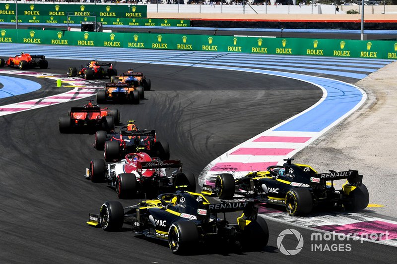 Charles Leclerc, Ferrari SF90, leads Max Verstappen, Red Bull Racing RB15, Carlos Sainz Jr., McLaren MCL34, Lando Norris, McLaren MCL34, Sebastian Vettel, Ferrari SF90, Pierre Gasly, Red Bull Racing RB15, Antonio Giovinazzi, Alfa Romeo Racing C38, Daniel Ricciardo, Renault F1 Team R.S.19, and Nico Hulkenberg, Renault F1 Team R.S. 19, on the opening lap