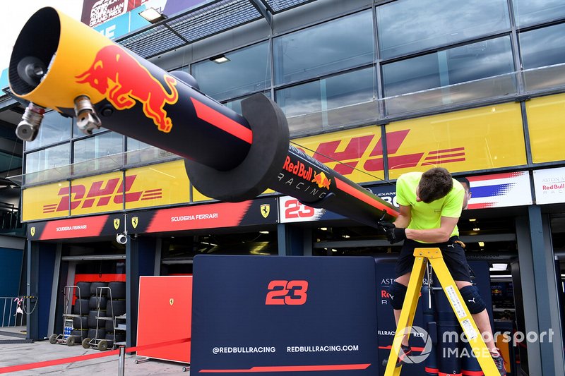 A member of the Red Bull team packs away equipment in the pits