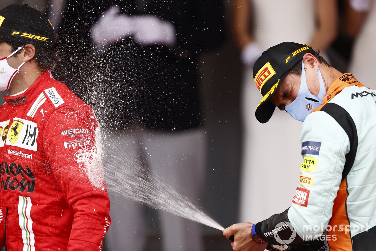 Lando Norris, McLaren, 3rd position, and Carlos Sainz Jr., Ferrari, 2nd position, celebrate on the podium with Champagne