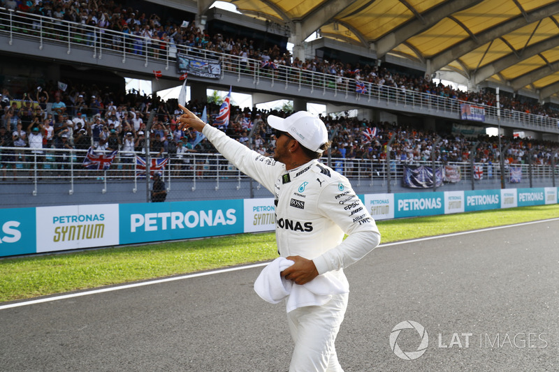 Lewis Hamilton, Mercedes AMG F1, waves to fans after setting pole position