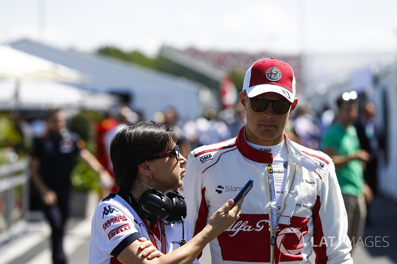 Marcus Ericsson, Sauber, talks to a press officer in qualifying
