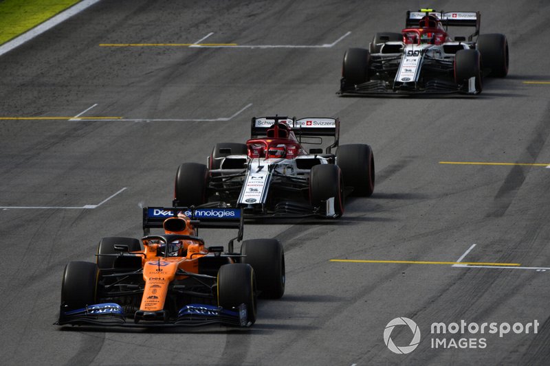 Carlos Sainz Jr., McLaren MCL34, leads Kimi Raikkonen, Alfa Romeo Racing C38, and Antonio Giovinazzi, Alfa Romeo Racing C38