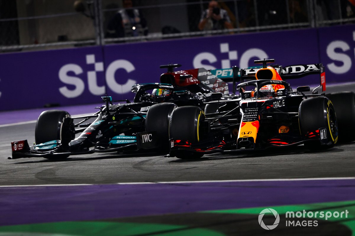 Max Verstappen, Red Bull Racing RB16B, and Lewis Hamilton, Mercedes W12, make contact as they battle for the lead