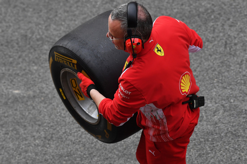 Un mecánico de Ferrari con un neumático Pirelli