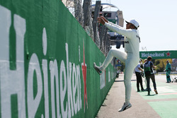 Race winner Lewis Hamilton, Mercedes AMG F1, climbs the pit wall