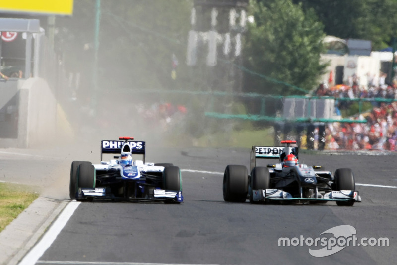 Michael Schumacher, Mercedes GP MGP W01 squeezes Rubens Barrichello, Williams FW32