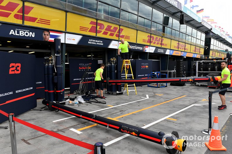 Red Bull personnel pack away equipment in the pitlane
