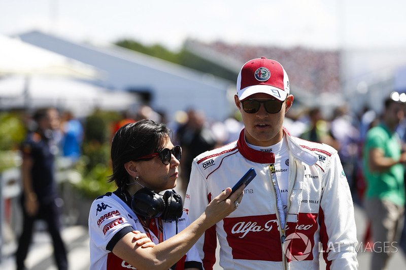 Marcus Ericsson, Sauber, talks to a press officer in qualifying