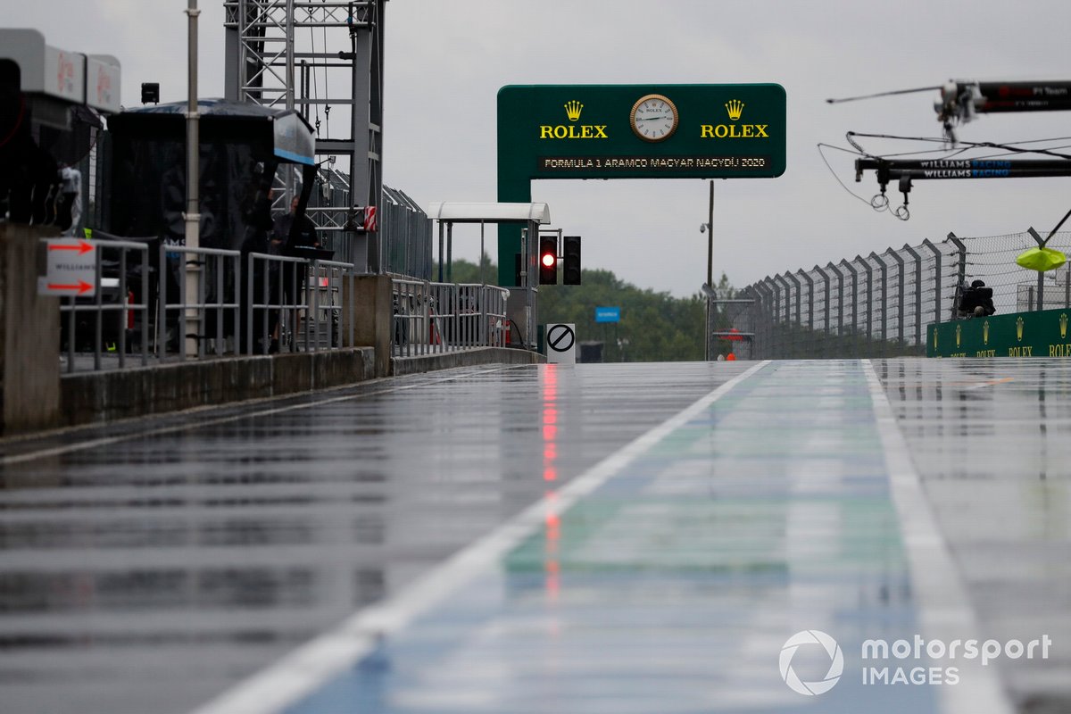 Rain soaks the pit lane