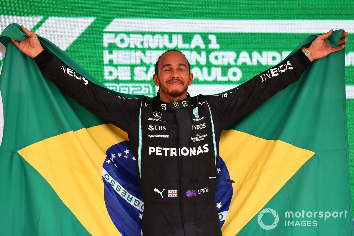 Lewis Hamilton, Mercedes, 1st position, on the podium with a Brazilian flag