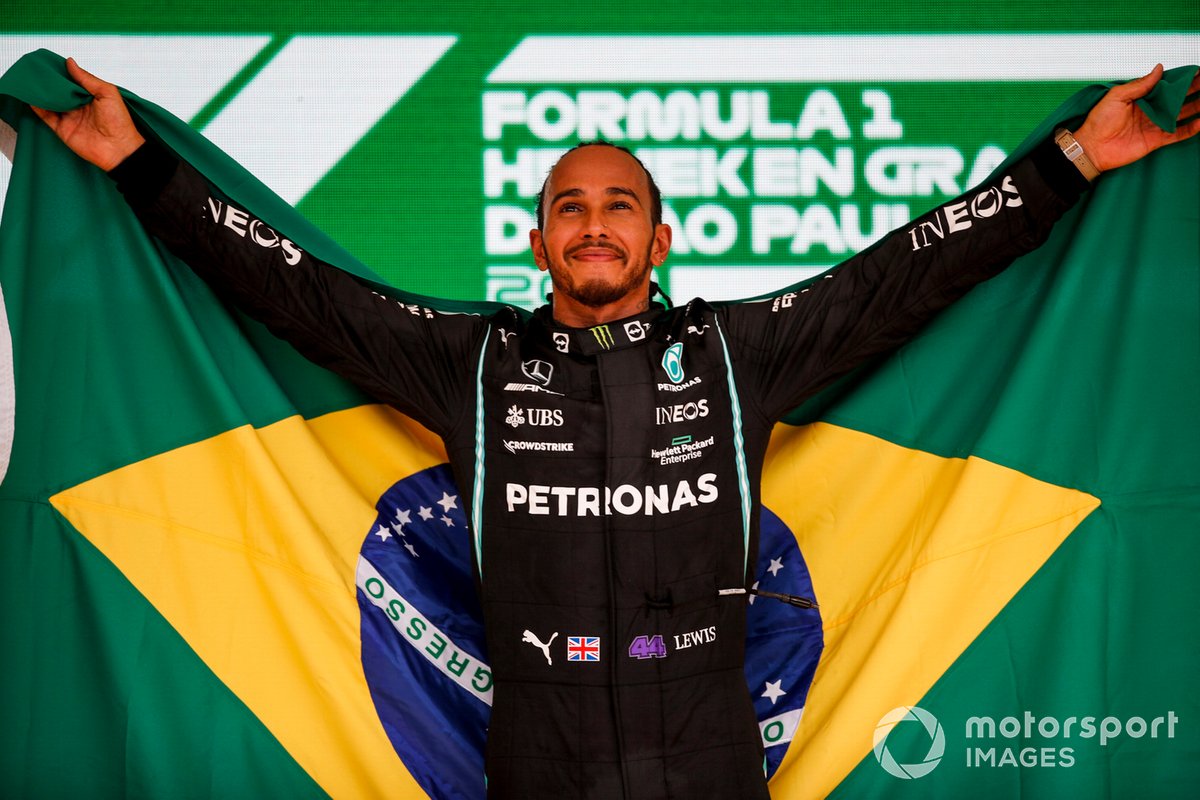 Lewis Hamilton, Mercedes, 1st position, with a Brazilian flag on the podium