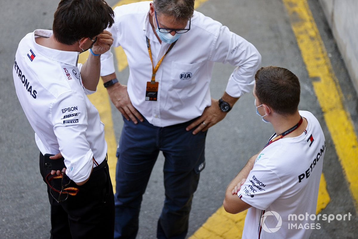 Toto Wolff, Executive Director (Business), Mercedes AMG, and Stoffel Vandoorne, Reserve Driver, Mercedes-AMG Petronas F1, talk with an FIA representative