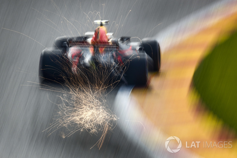 Sparks fly from the rear of Max Verstappen, Red Bull Racing RB13