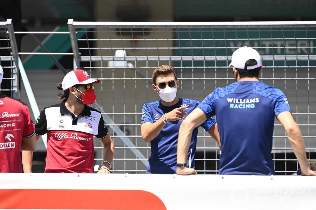 Pilot Italia Antonio Giovinazzi (Alfa Romeo Racing) berbincang dengan pembalap Inggris George Russell (Williams) jelang F1 GP Austria 2021.