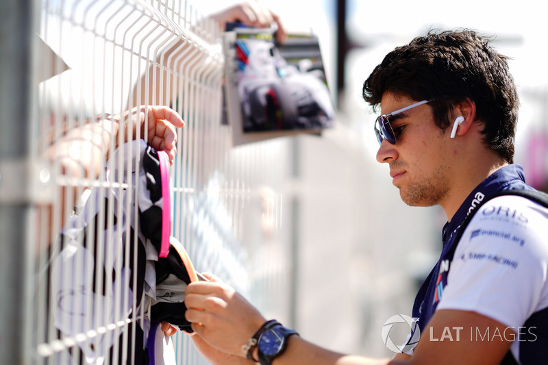 Lance Stroll, Williams Racing, signs autographs for fans