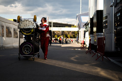 Ferrari mechanic with Pirelli tyres in the paddock
