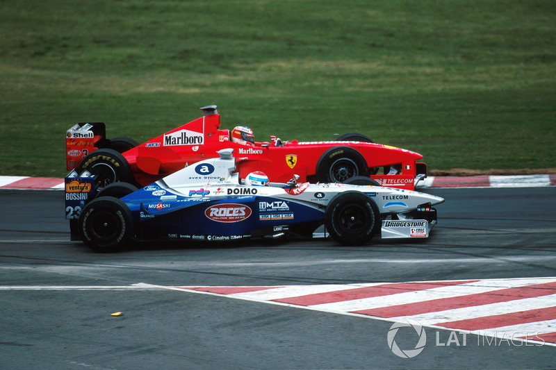 Michael Schumacher, Ferrari F300 laps Marc Gene, Minardi Ford M198