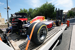 The damaged Red Bull Racing RB12 of Daniel Ricciardo, is recovered back to the pits on the back of a truck