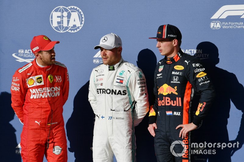 Valtteri Bottas, Mercedes AMG F1, celebrates with Sebastian Vettel, Ferrari, and Max Verstappen, Red Bull Racing, after taking Pole Position