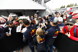 Daniel Ricciardo, Red Bull Racing, and Max Verstappen, Red Bull Racing, sign autographs for fans