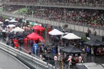Cars on the grid as the race is stopped during a thunderstorm
