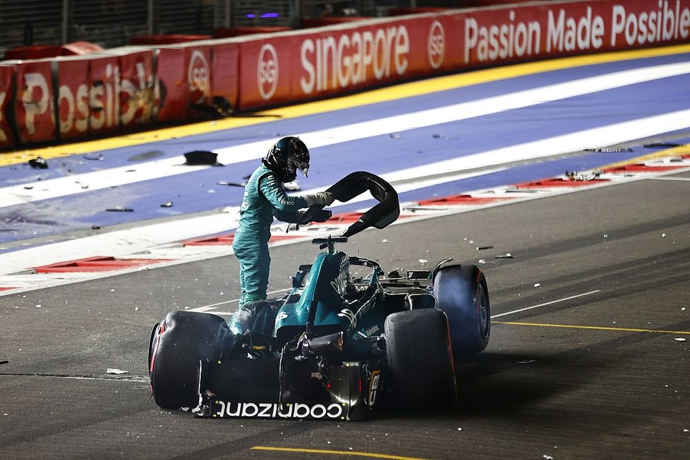 Lance Stroll, Aston Martin AMR23, climbs out of his heavily damaged car after a crash towards the end of Q1