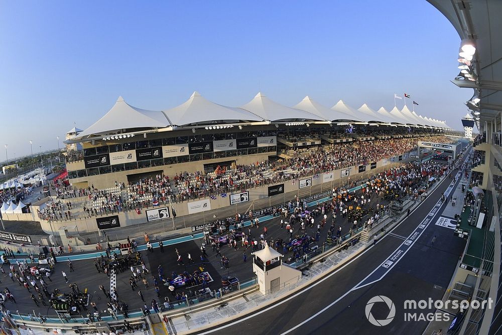 A scenic view of personnel and cars on the grid