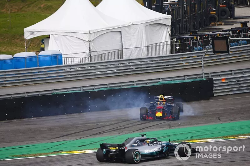 Lewis Hamilton, Mercedes AMG F1 W09, passes a spinning Max Verstappen, Red Bull Racing RB14 Tag Heuer, after the latter suffers a collision with Esteban Ocon, Force India VJM11 Mercedes. 