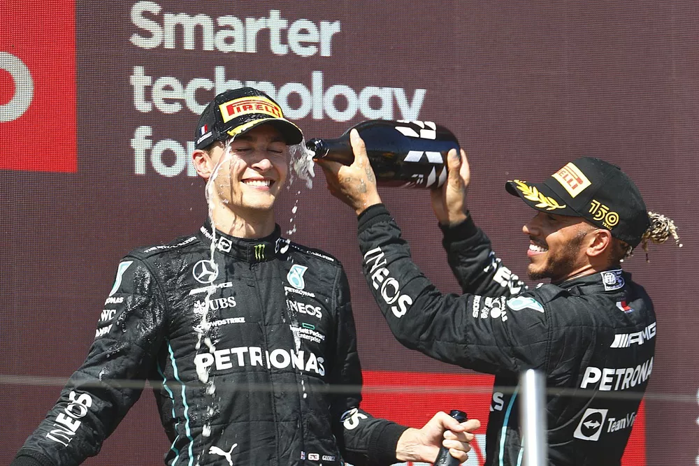 Lewis Hamilton, Mercedes-AMG, 2nd position, sprays George Russell, Mercedes-AMG, 3rd position, with Champagne on the podium