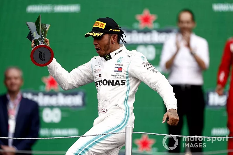 Lewis Hamilton, Mercedes AMG F1, 1st position, on the podium with his trophy