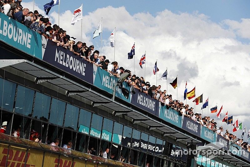 Fans watch action from above the pit lane