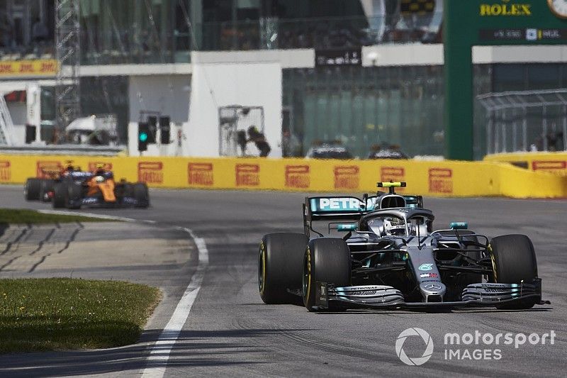 Valtteri Bottas, Mercedes AMG W10, leads Lando Norris, McLaren MCL34