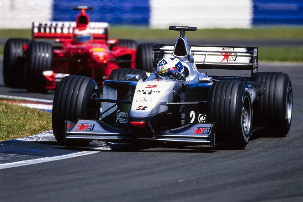 David Coulthard, McLaren MP4-14 Mercedes, leads Eddie Irvine, Ferrari F399.