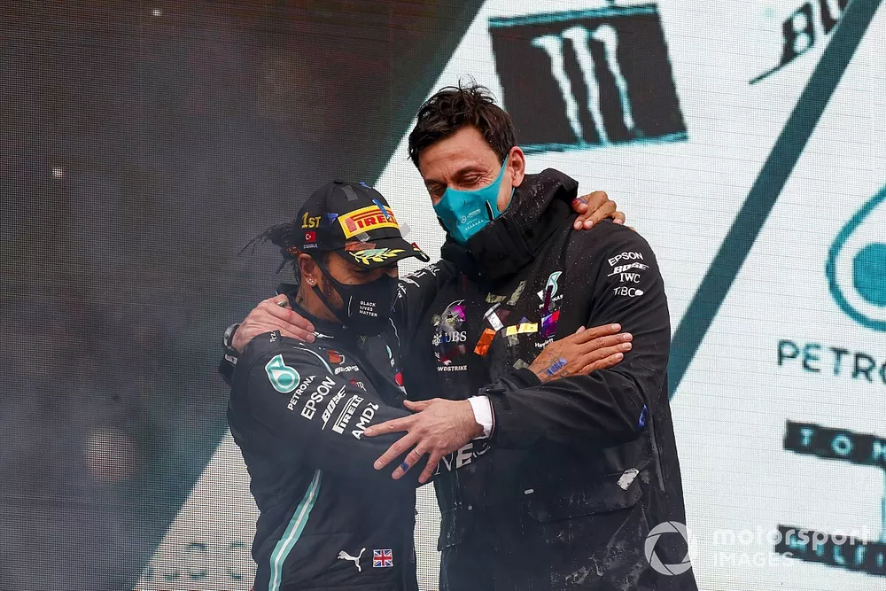 Lewis Hamilton, Mercedes-AMG F1, 1st position, and Toto Wolff, Executive Director (Business), Mercedes AMG, celebrate on the podium after securing a seventh world drivers title on the podium