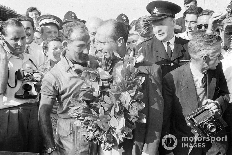 Stirling Moss le da la guirnalda de su ganador a Juan Manuel Fangio