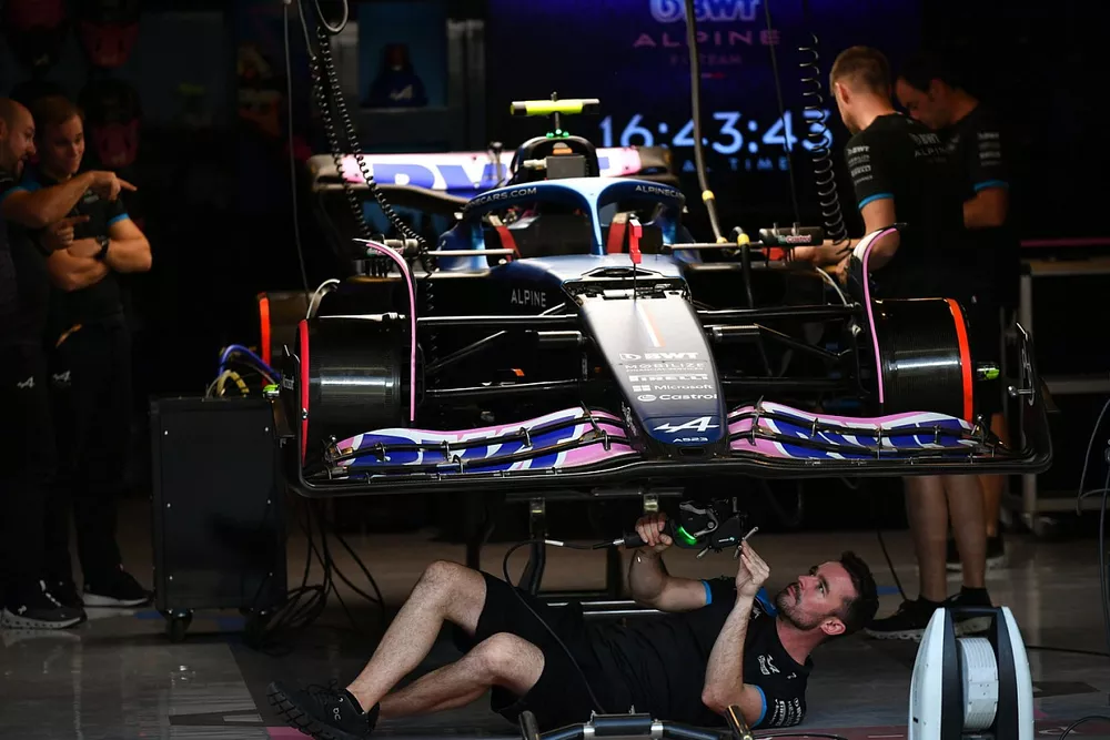 Mechanics work on the car of Pierre Gasly, Alpine A523 