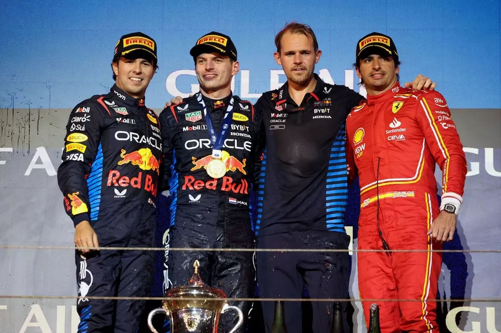 Sergio Perez, Red Bull Racing, 2nd position, Max Verstappen, Red Bull Racing, 1st position, the Red Bull trophy delegate and Carlos Sainz, Scuderia Ferrari, 3rd position, on the podium