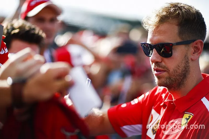 Sebastian Vettel, Ferrari, signs an autograph for fans
