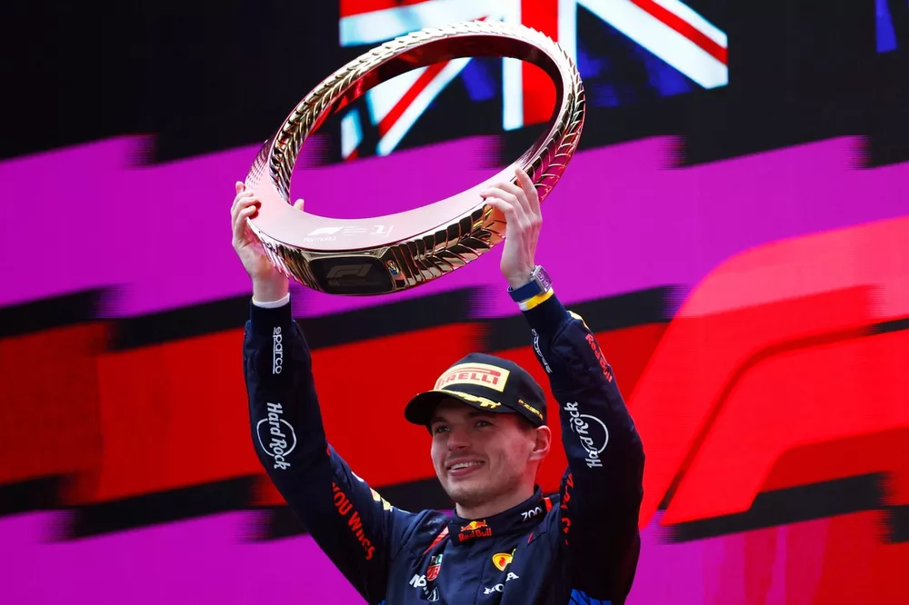 Max Verstappen, Red Bull Racing, 1st position, lifts the trophy in celebration 
