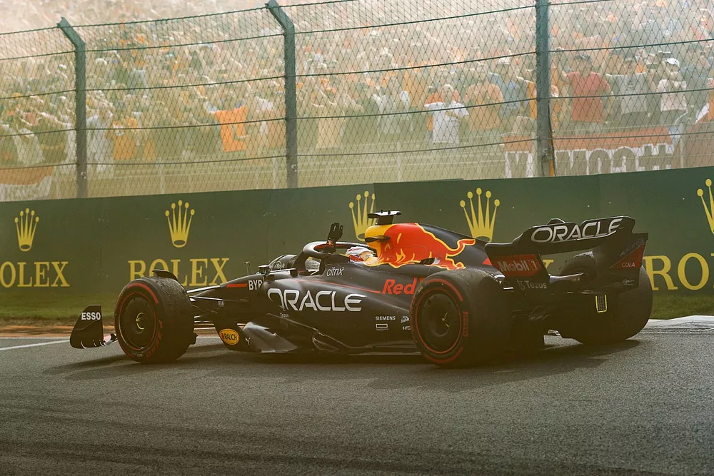 Le vainqueur Max Verstappen, Red Bull Racing RB18, dans le tour de d&eacute;c&eacute;l&eacute;ration sous la fum&eacute;e orange