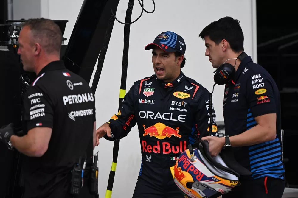 Sergio Perez, Red Bull Racing, with his performance coach Jose Canales in the pit lane
