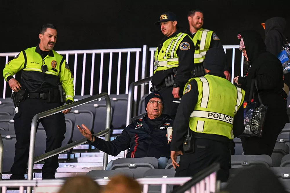 Police eject fans from a grandstand