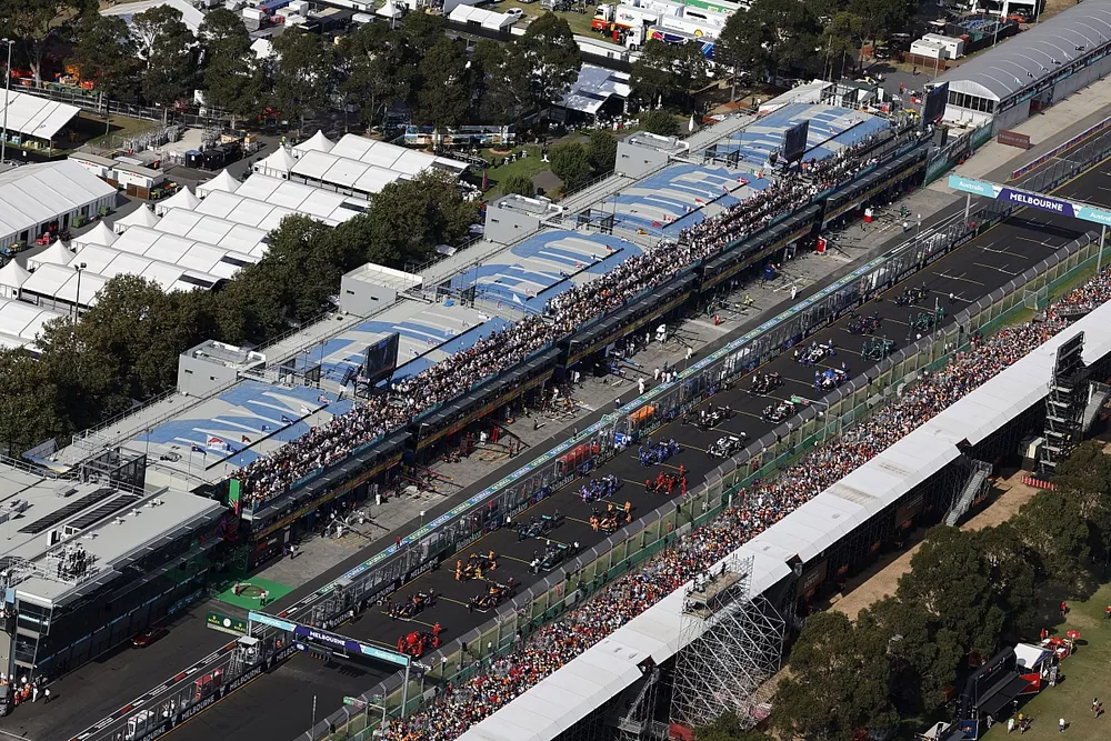 Mechanics on the grid with the cars prior to the start