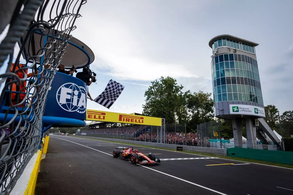 The chequered flag is waved as Charles Leclerc, Ferrari SF-24, 1st position, crosses the finish line