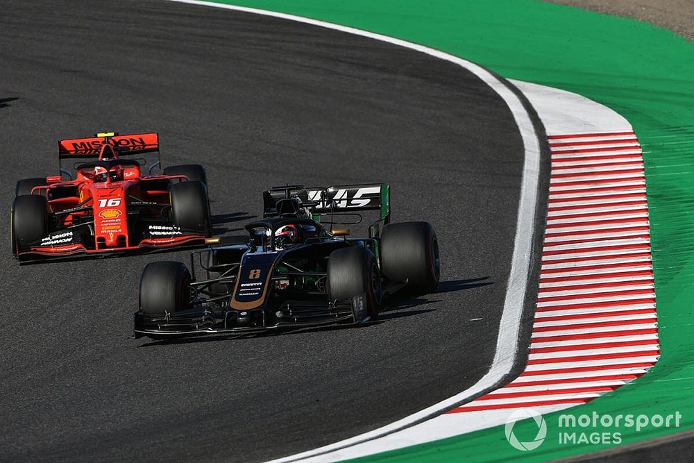 Romain Grosjean, Haas F1 Team VF-19, leads Charles Leclerc, Ferrari SF90